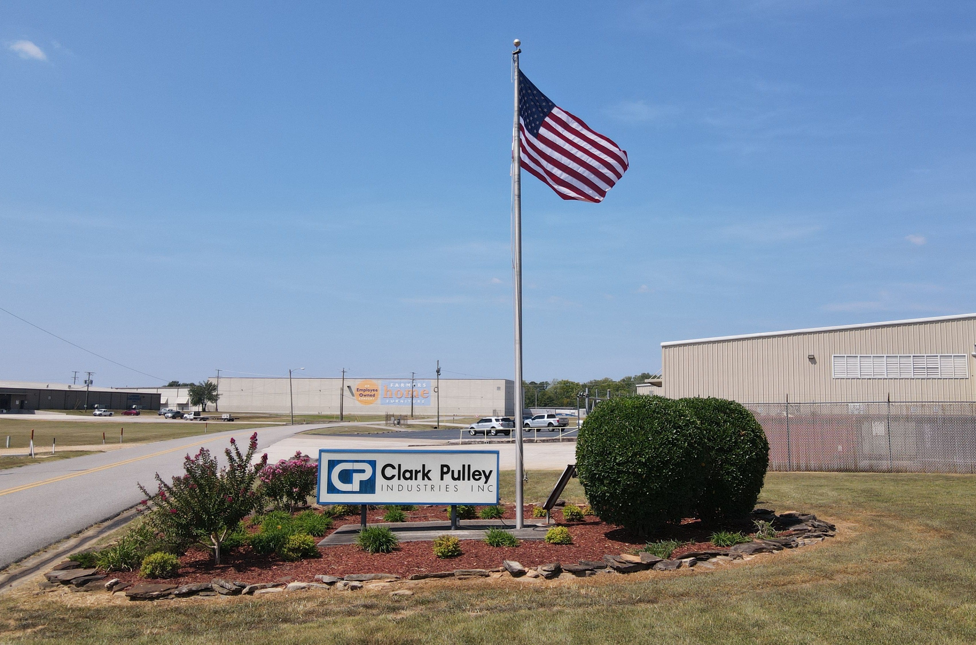 A sign that says clark valley and an american flag.