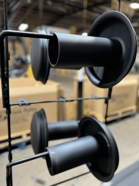 A close up of some black poles in a warehouse