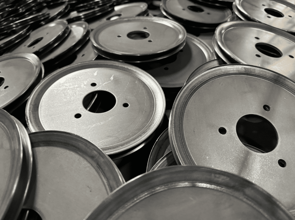 A pile of metal wheels sitting on top of each other.