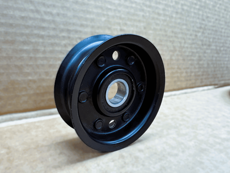 A black wheel with two holes in it.